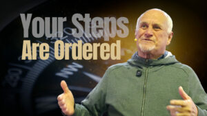 A pastor speaking next to the text "Your Steps Are Ordered," illustrating the reality of the Holy Spirit Working to direct our daily decisions.