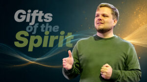 Featured graphic for the 'Gifts of the Spirit' sermon, showing a pastor teaching in a green sweater against a dark background with glowing spiritual light waves.
