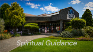 A welcoming view of people gathering outside the Fountain of Life church building, overlaid with the title text "Spiritual Guidance".